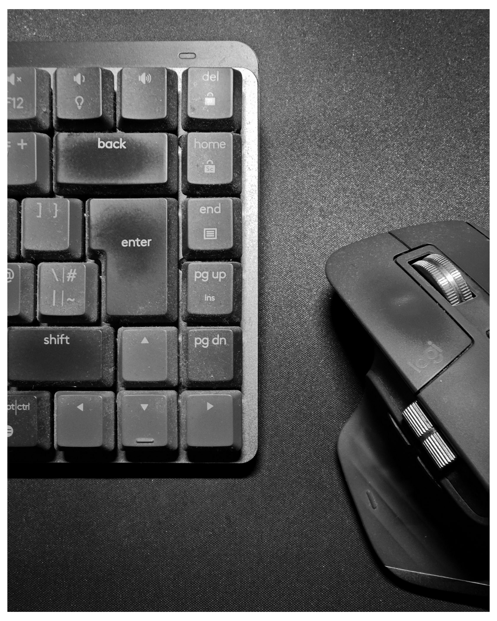 Close up image of a Logitech MX Master series black and grey keyboard and mouse