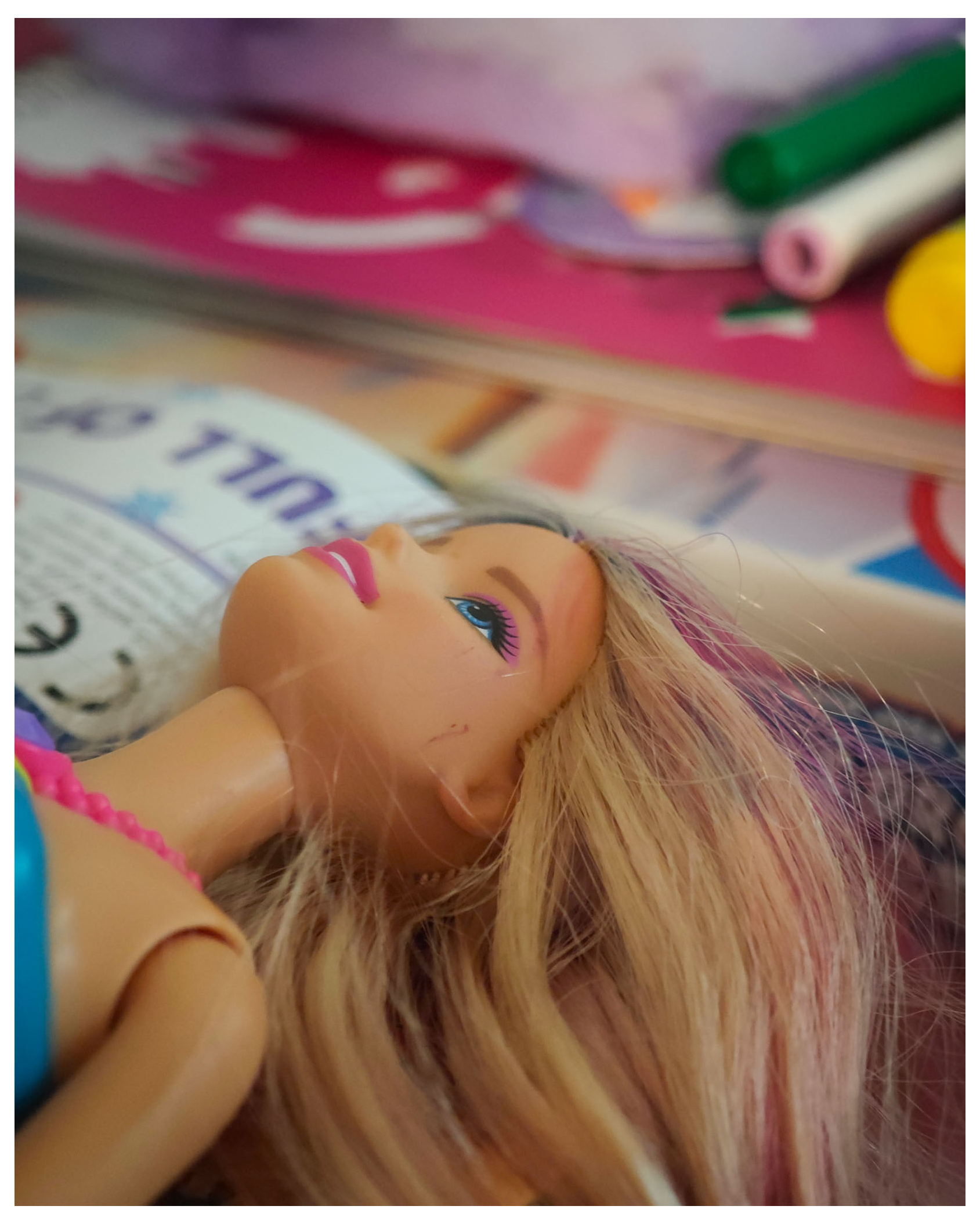 Close up of a Barbie Doll with other children's toys in the background